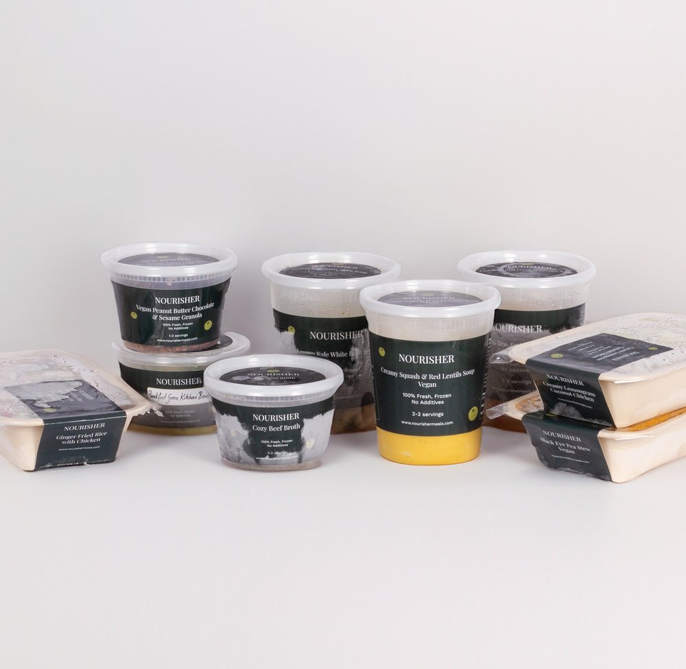 A collection of prepared meals in containers with labels, displayed on a white background.