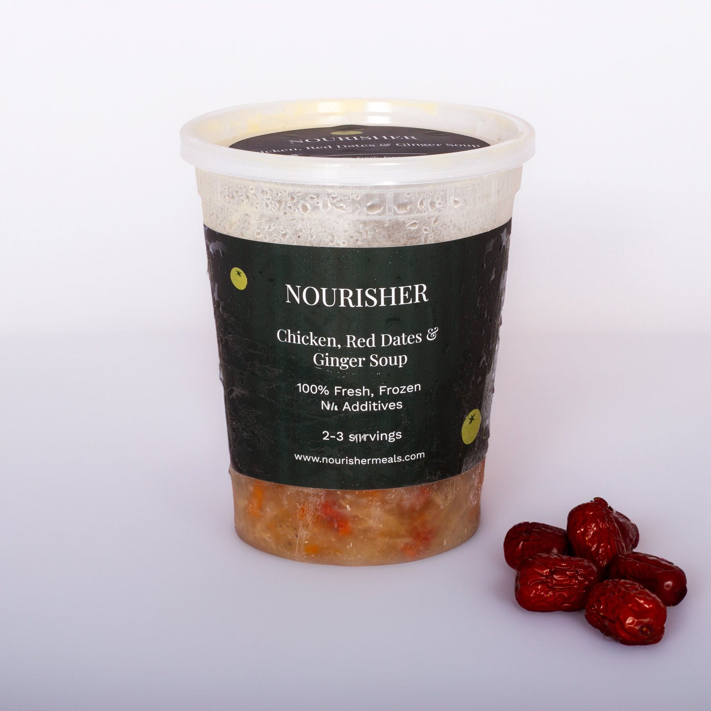 A packaged unit of Chicken, Red Dates & Ginger Soup with the soup still hot and red dates and ginger slices visible in the bowl, on a light background.