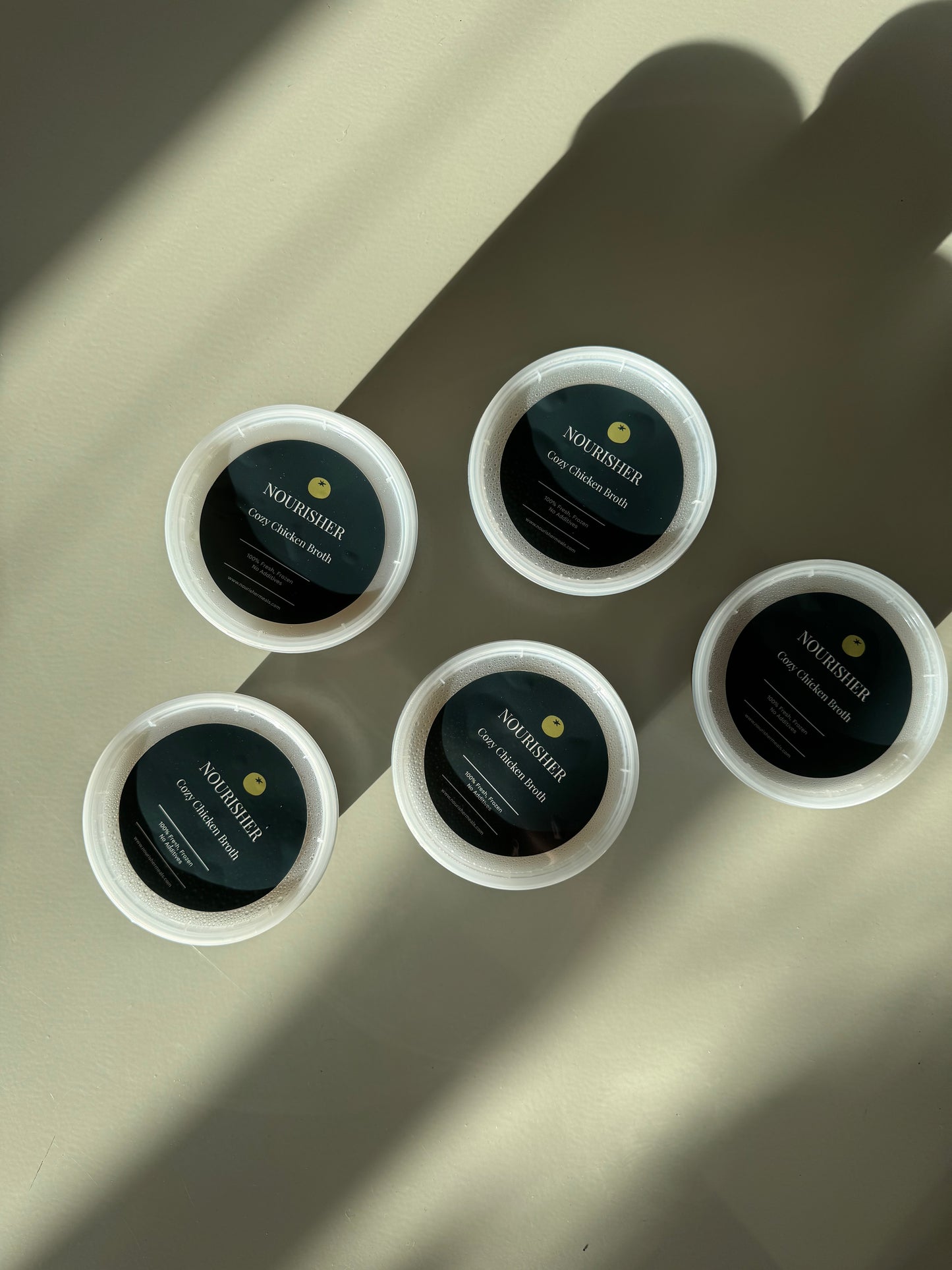 Packaged containers with cozy chicken broth