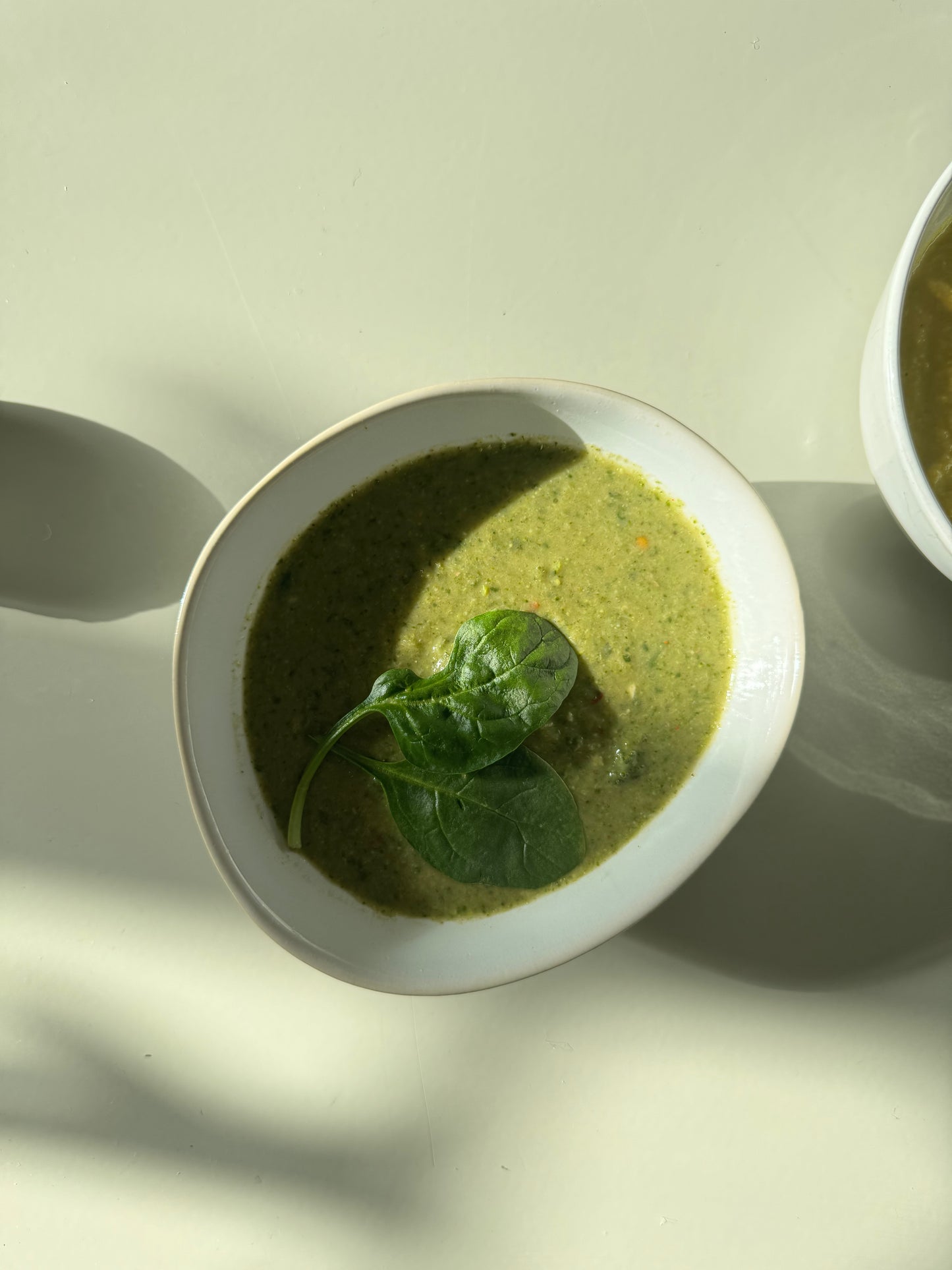 Peas soup in a bowl with shadow