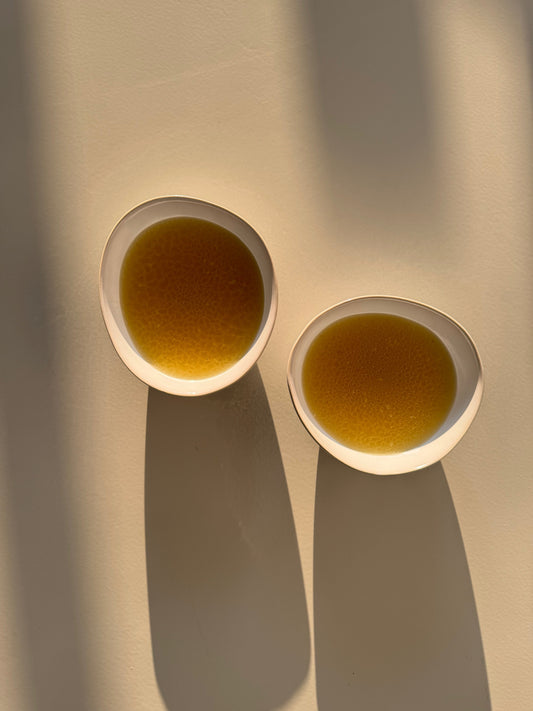 Bone broth in a ceramic bowl, ideal for postpartum healing meals