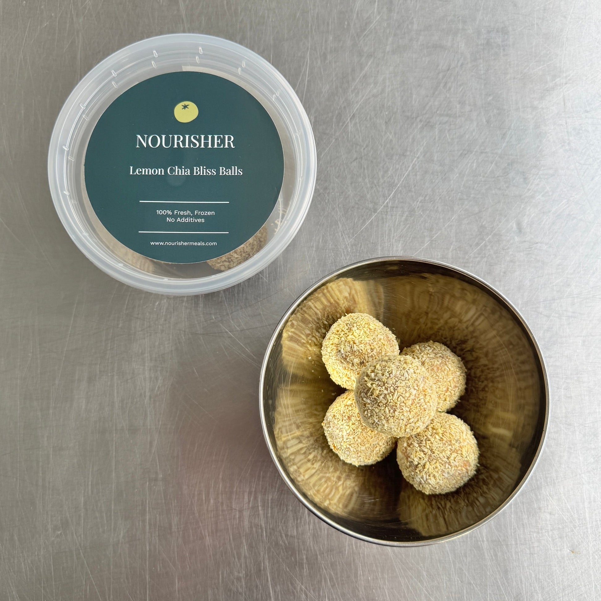 Container of lemon thyme tea balls on a metallic surface